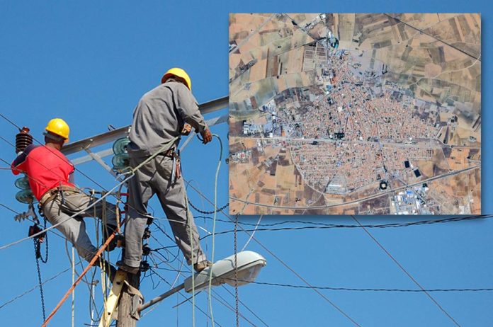 Low angle shot of electric linemen working on pole